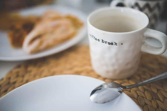 white coffee cup with coffee break written on it