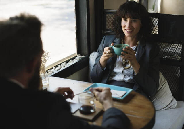 male and female colleagues sharing coffee break